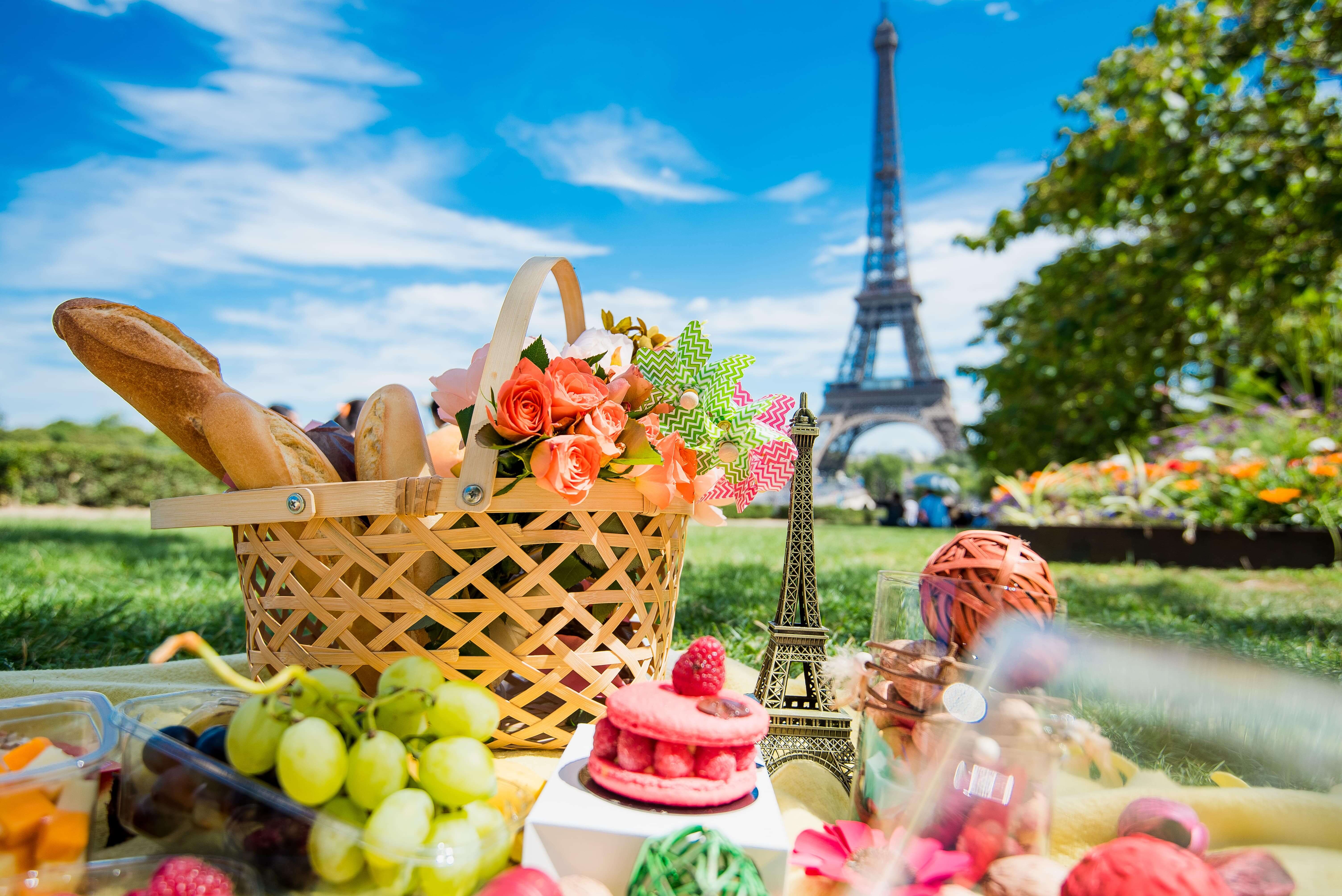 Picnic in Paris with wine, fruits and different french tasty dishes